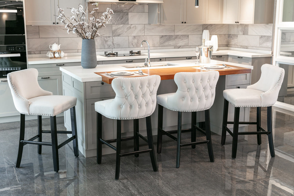 A&A Furniture, Contemporary Velvet Upholstered Wing-Back Barstools with Button Tufted Decoration and Wooden Legs, and Chrome Nailhead Trim - Beige