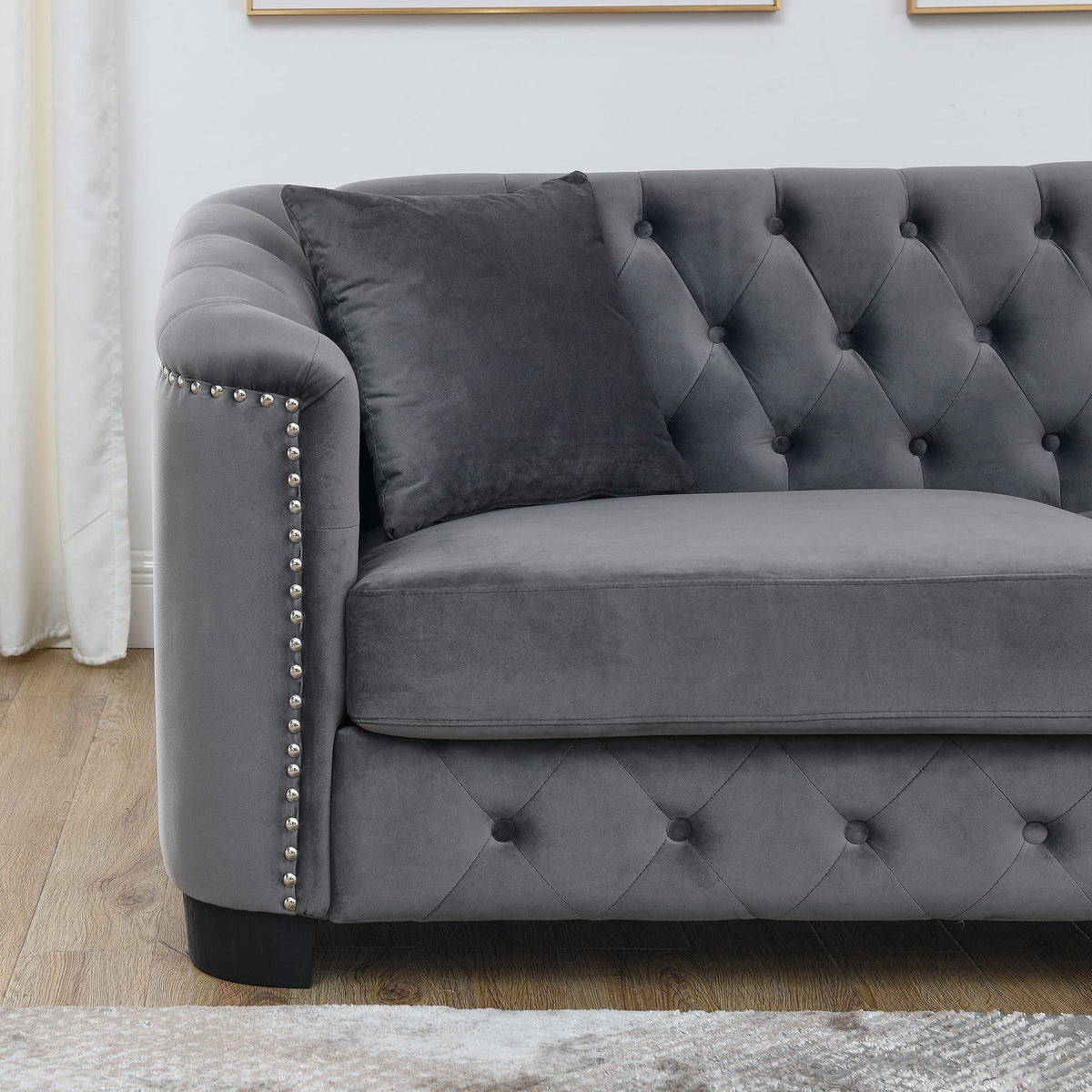 Velvet Chelsfield Sofa Set, featuring extra-deep seat cushions with padded armrests, tufted buttons, and brass studs, complete with throw pillows and plastic legs