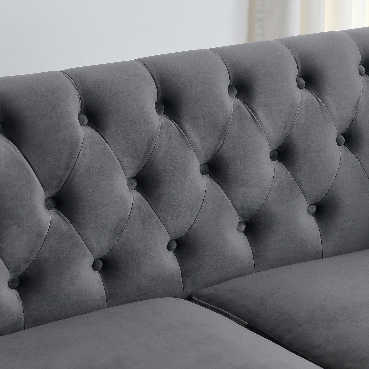 Velvet Chelsfield Sofa Set, featuring extra-deep seat cushions with padded armrests, tufted buttons, and brass studs, complete with throw pillows and plastic legs